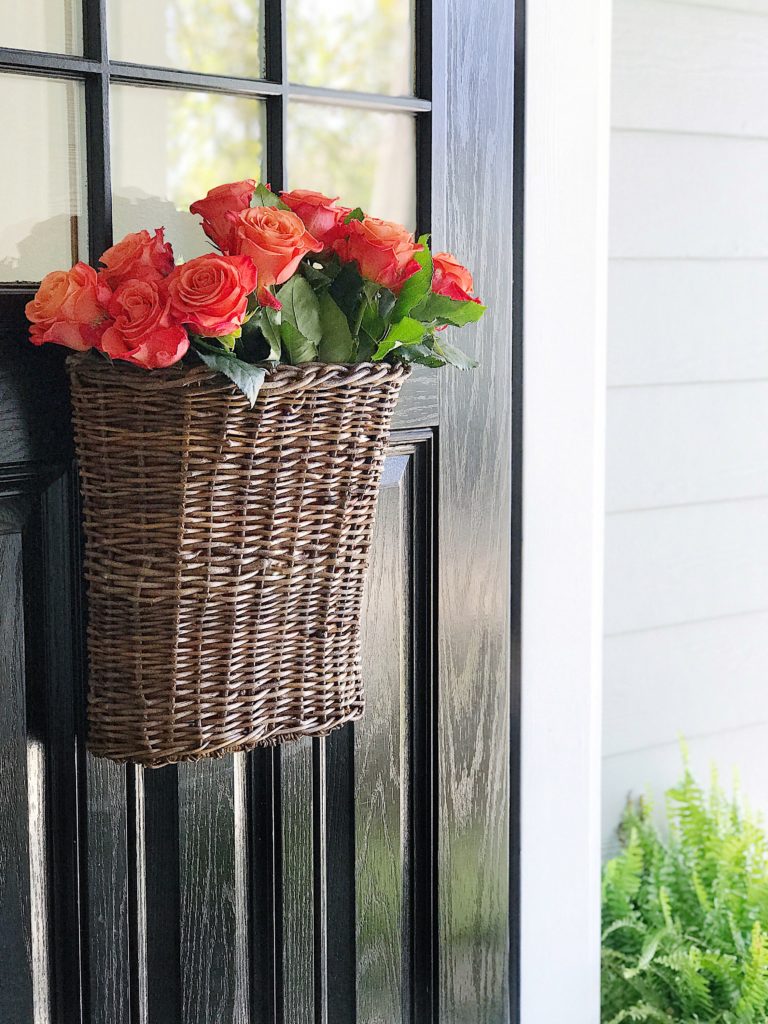 Fall front door decoration with a basket of roses - jane at home